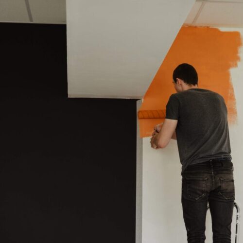 man-painting-the-wall-orange-black-repairing-b-2024-12-03-09-13-57-utc man-painting-the-wall-orange-black-repairing-b-2024-12-03-09-13-57-utc